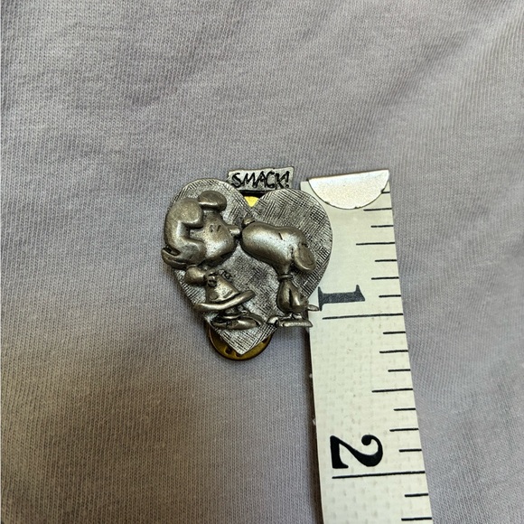 Peanuts Jewelry - Heart-Shaped Pewter Pin starring Snoopy kissing Lucy on the nose